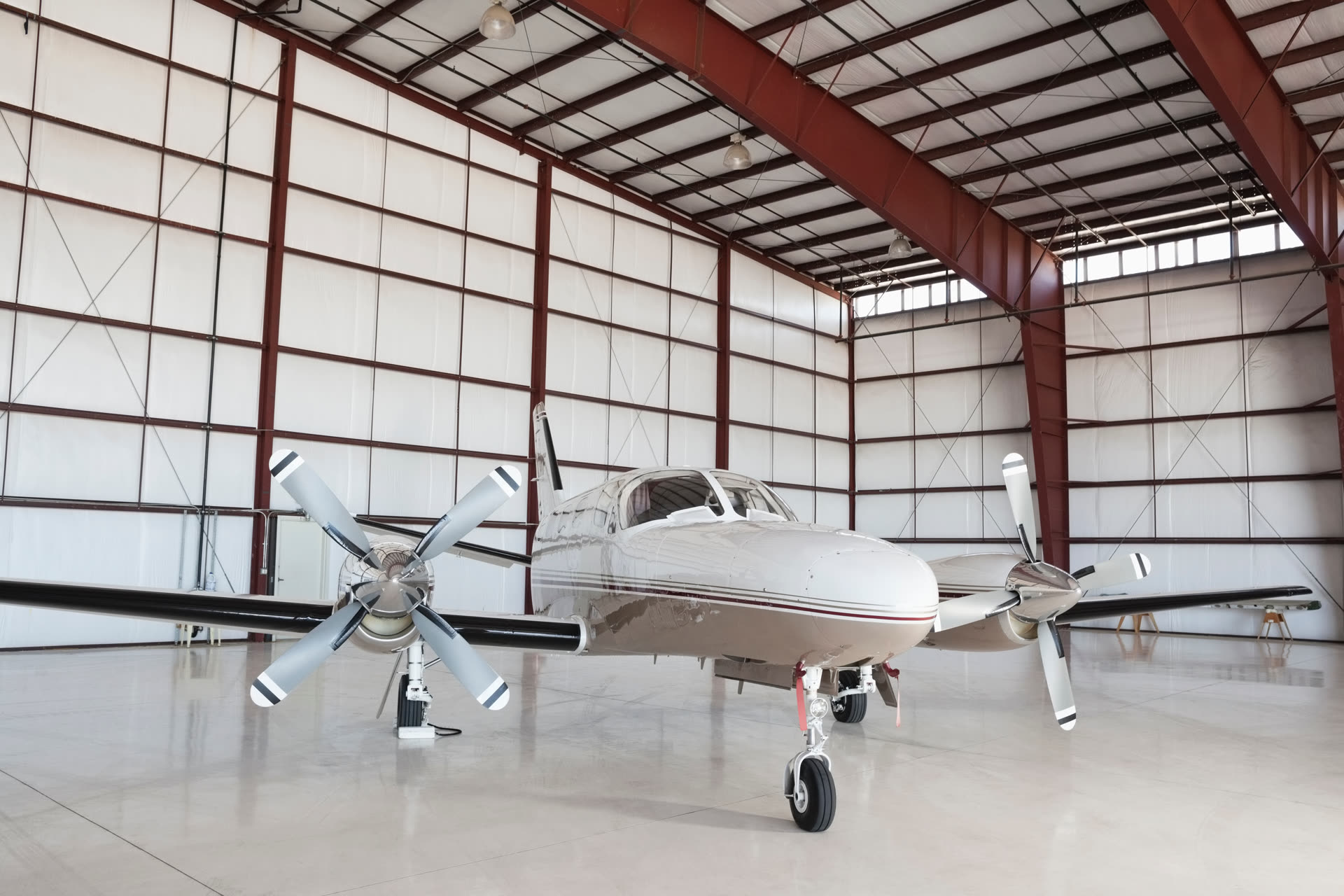 Twin-engine general aviation airplane parked inside a hangar