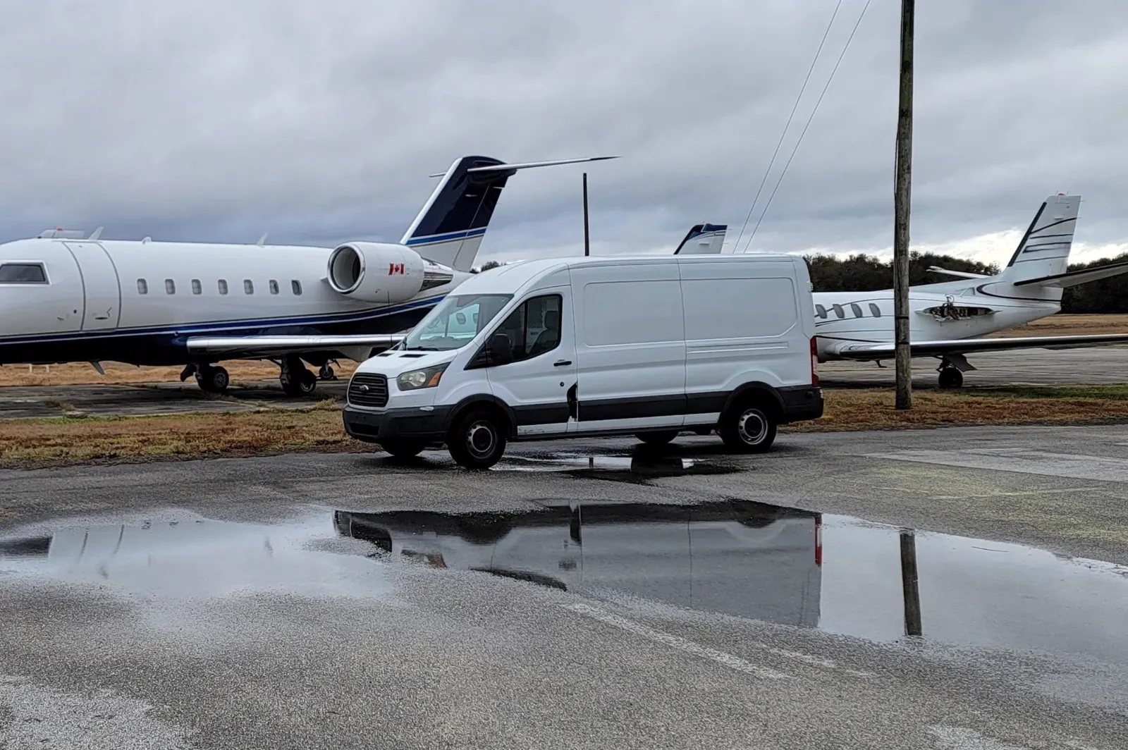 Alpha Company Aviation mobile aircraft maintenance unit parked between two jets on a Southeast ramp